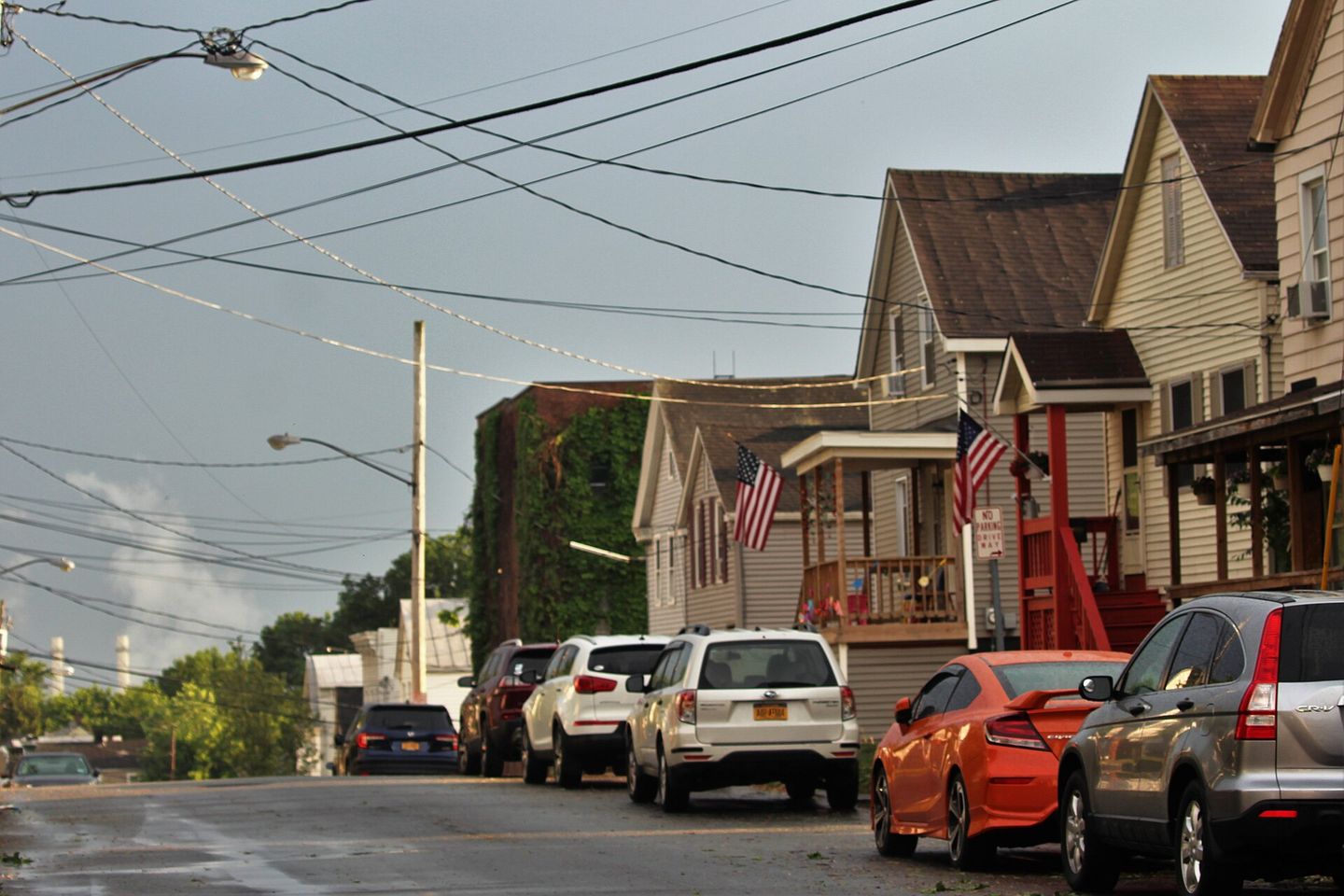 Frame houses with porches and parked cars on 3rd Street in Rensselaer, New York